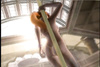 Sexy vixen familiarizes herself with a stripper pole in an attempt to perform.
